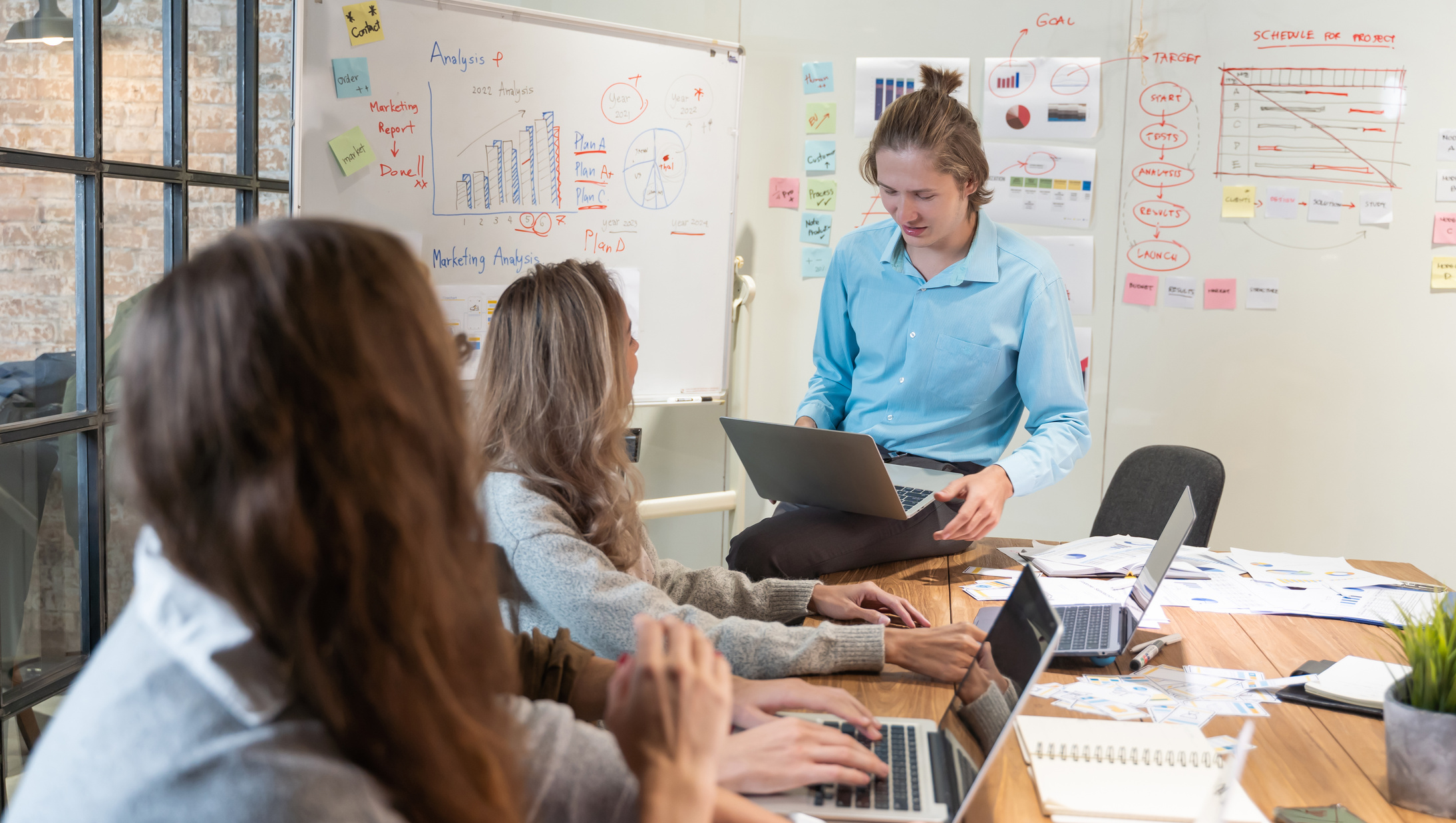 Leader Discussing Work on Laptop in Conference Room
